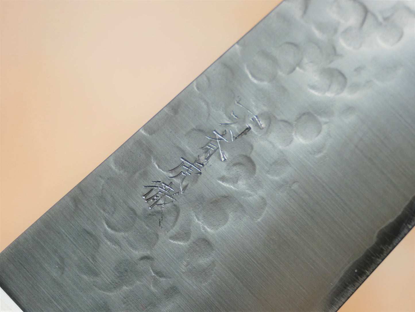 Maker's mark on blade face of 210mm VG10 gyuto forged by Takahashikusu