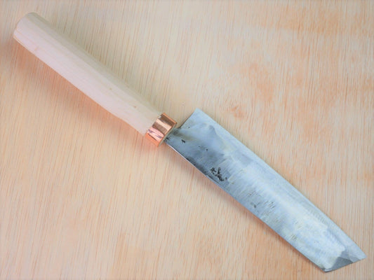 Shirogami No.3 Nakiri forged by Tsutomu Takahashi laying on wooden background with it's cutting edge facing north