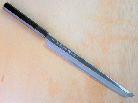 270mm VG10 Takohiki forged by Takahashikusu laying on wooden background with it's cutting edge facing south